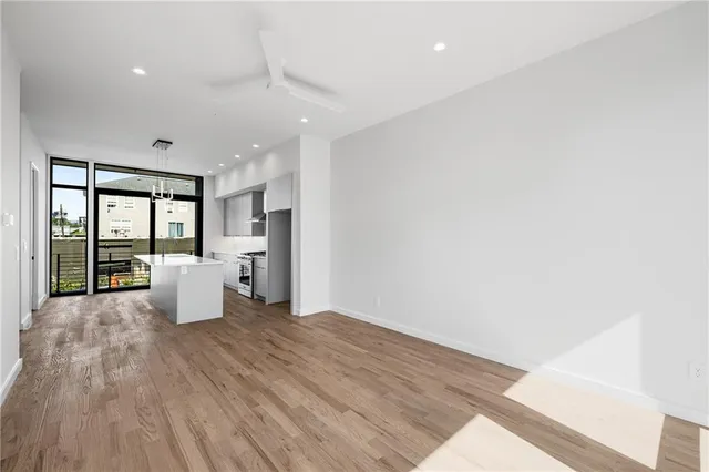 a view of a kitchen with a sink and wooden floor