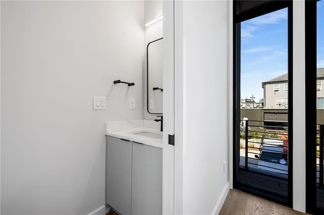 a bathroom with a granite countertop sink and washing machine