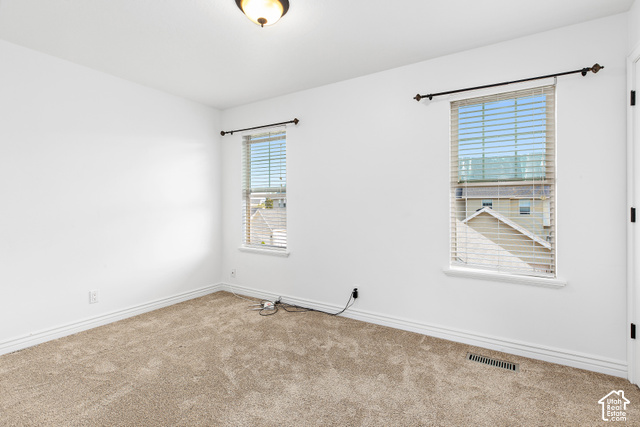 2092 Cres Drive South Mapleton, UT 84664 - Photo 15 of 26 Neutral-toned carpeting paired with white walls, two windows featuring horizontal blinds, and a ceiling-mounted light fixture