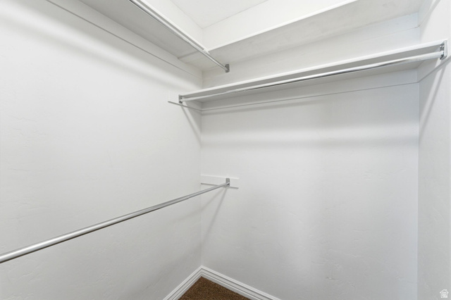 7235 Viansa Court Midvale, UT 84047 - Photo 22 of 43 Walk in closet featuring dark carpet