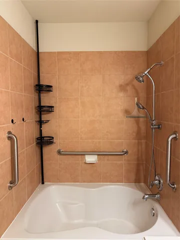 a bathroom with a bathtub and a shower