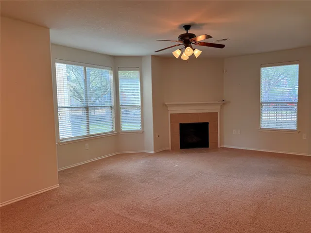 a view of empty room with a fireplace
