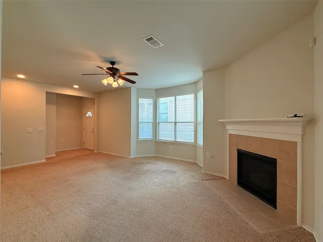 a view of an empty room with a fireplace