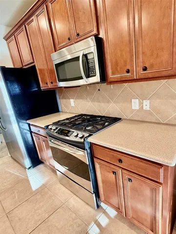 a stove top oven sitting inside of a kitchen
