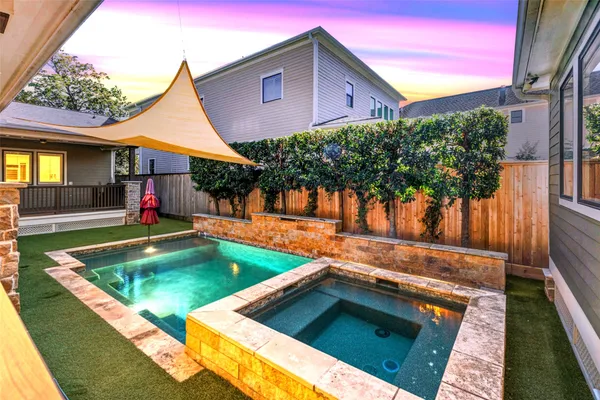 a view of a backyard with swimming pool