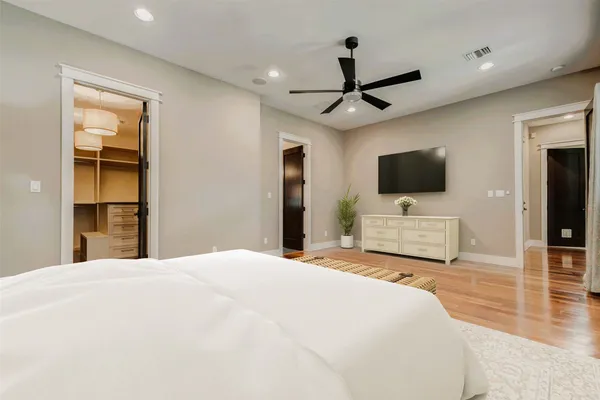 a bedroom with a bed and a flat screen tv