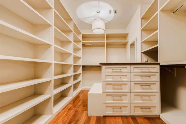 a view of walk in closet with empty racks