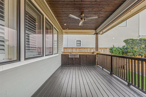 a view of a porch with wooden floor and iron stairs