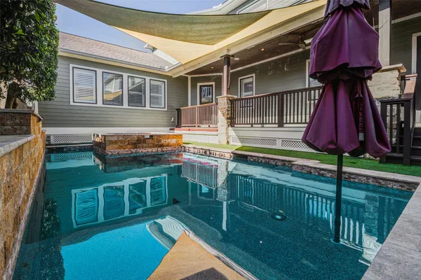 a backyard of a house with barbeque oven table and chairs