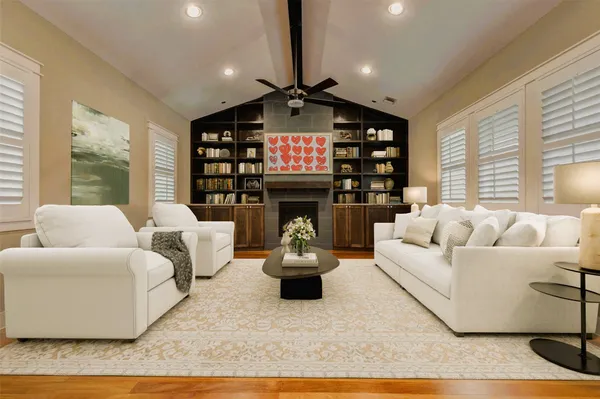 a living room with furniture a fireplace and a chandelier