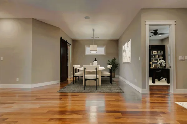 a living room with furniture a dining table and a fireplace