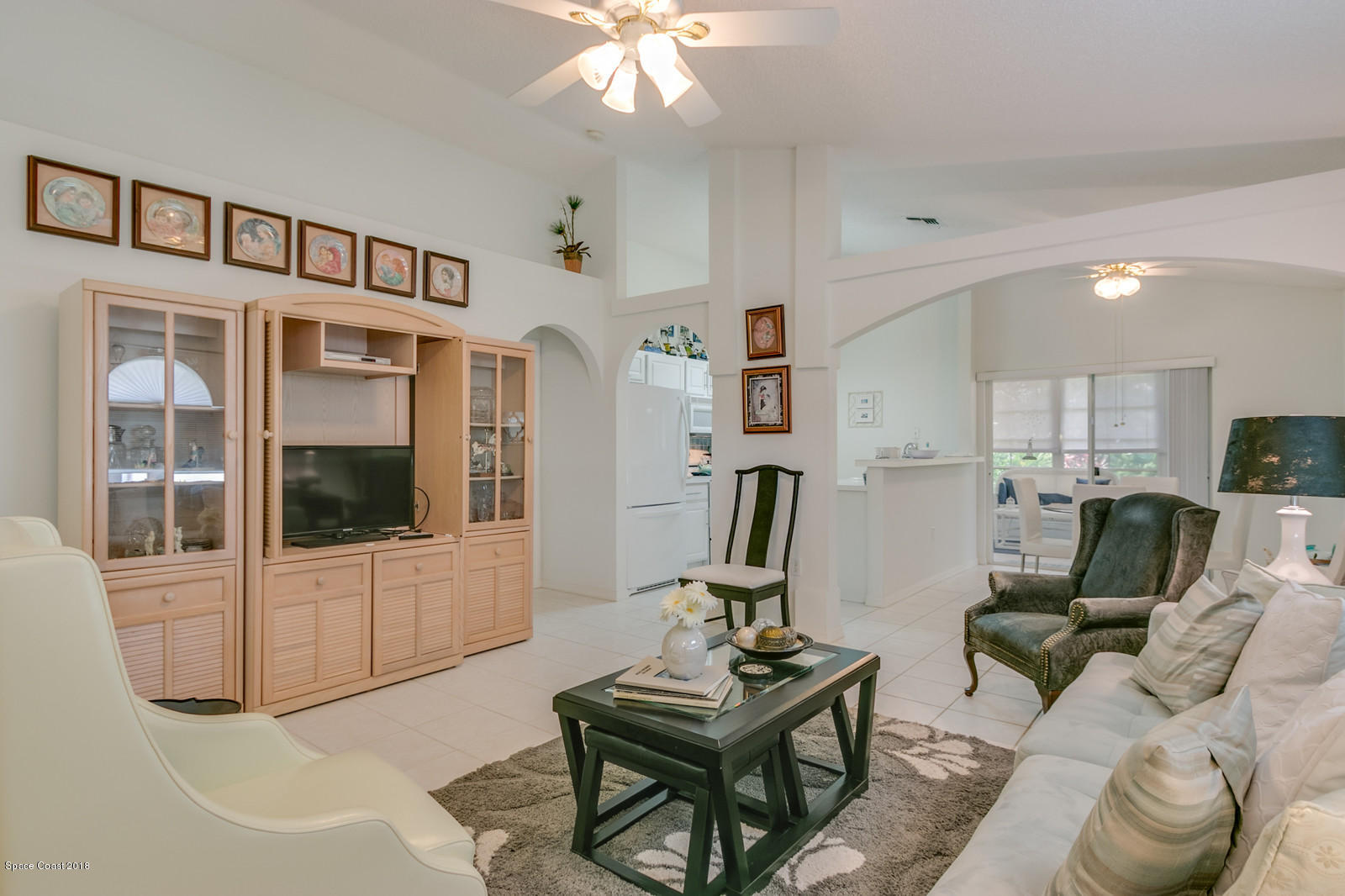 2009 Redwood Circle Palm Bay, FL 32905 - Photo 11 of 32 a living room with furniture a flat screen tv and kitchen view