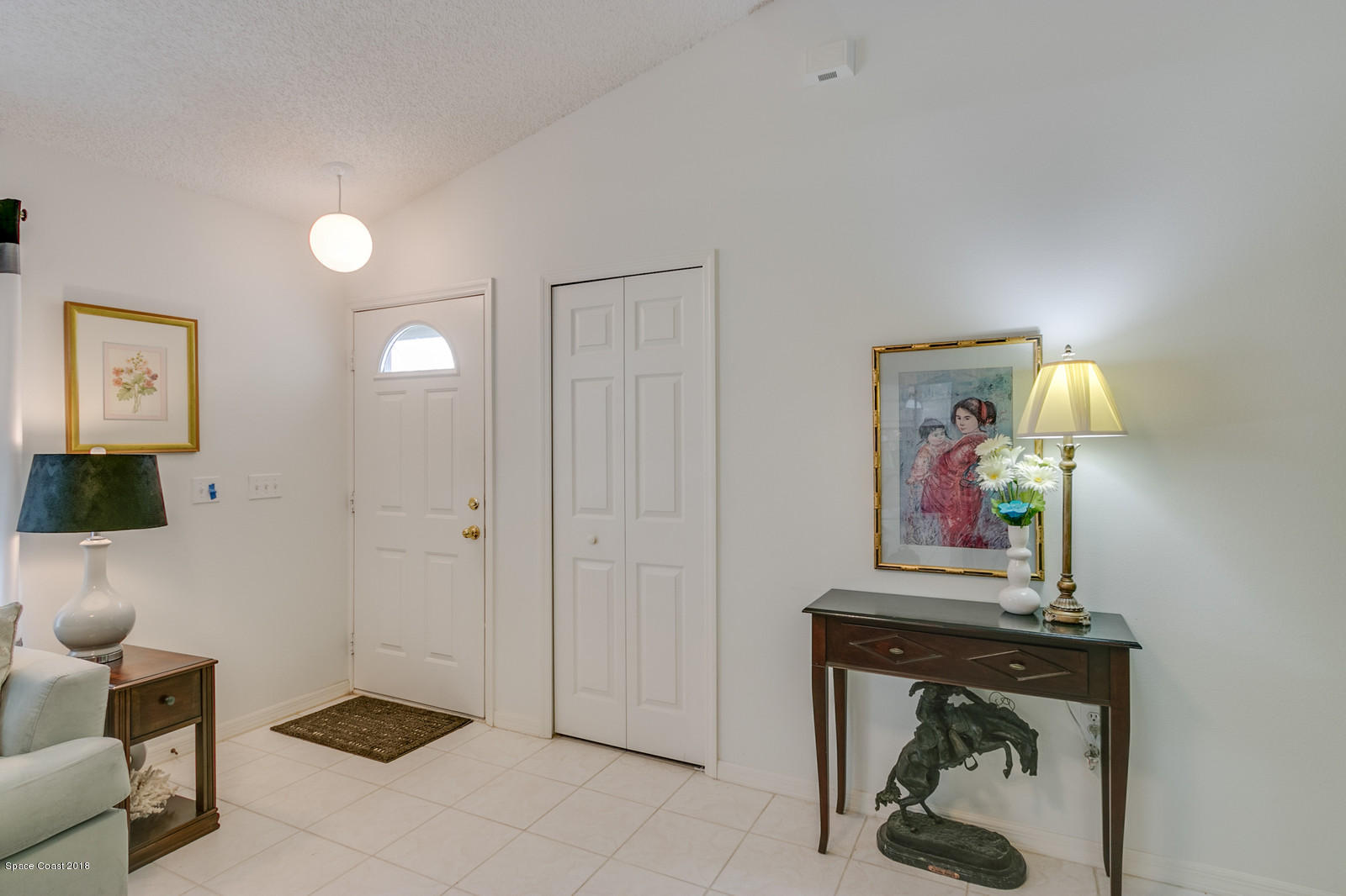 2009 Redwood Circle Palm Bay, FL 32905 - Photo 12 of 32 a living room with furniture and a painting on the wall