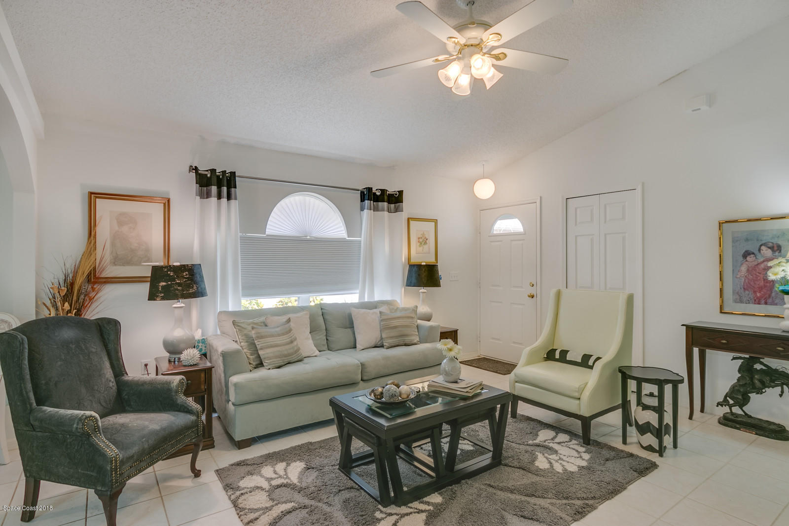 2009 Redwood Circle Palm Bay, FL 32905 - Photo 13 of 32 a living room with furniture a ceiling fan and a rug