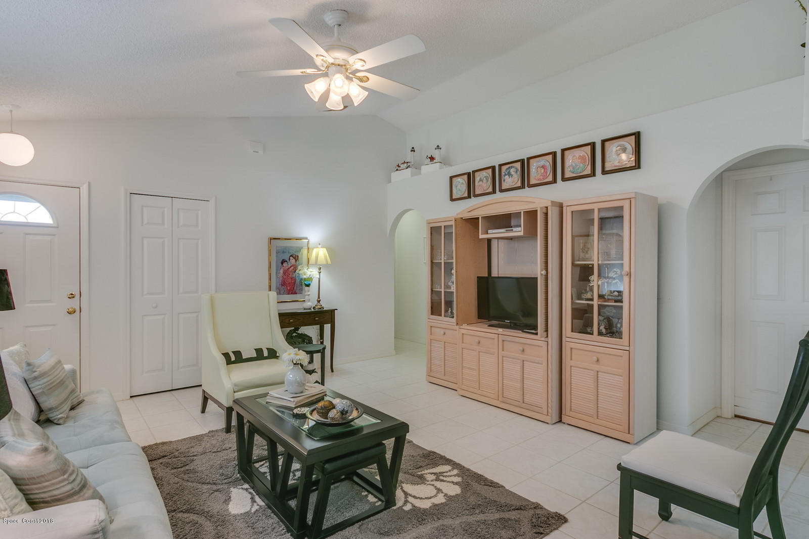 2009 Redwood Circle Palm Bay, FL 32905 - Photo 14 of 32 a living room with furniture a dining table and a piano with wooden floor