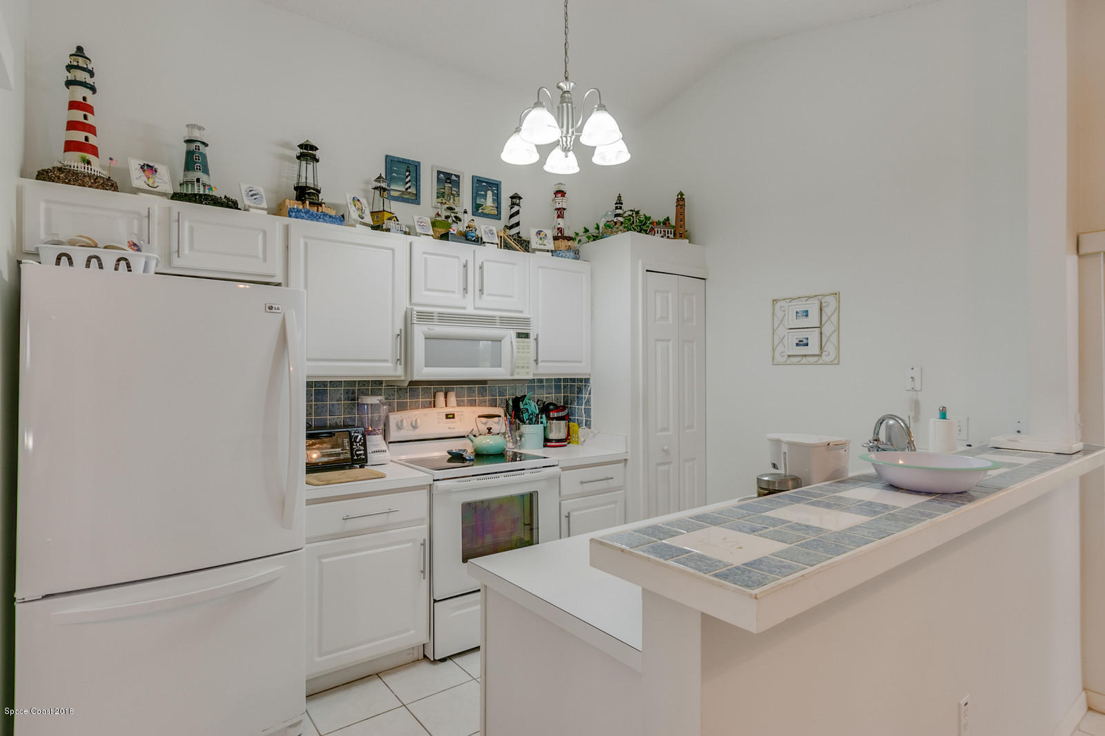 2009 Redwood Circle Palm Bay, FL 32905 - Photo 16 of 32 a kitchen with granite countertop a sink stainless steel appliances and white cabinets