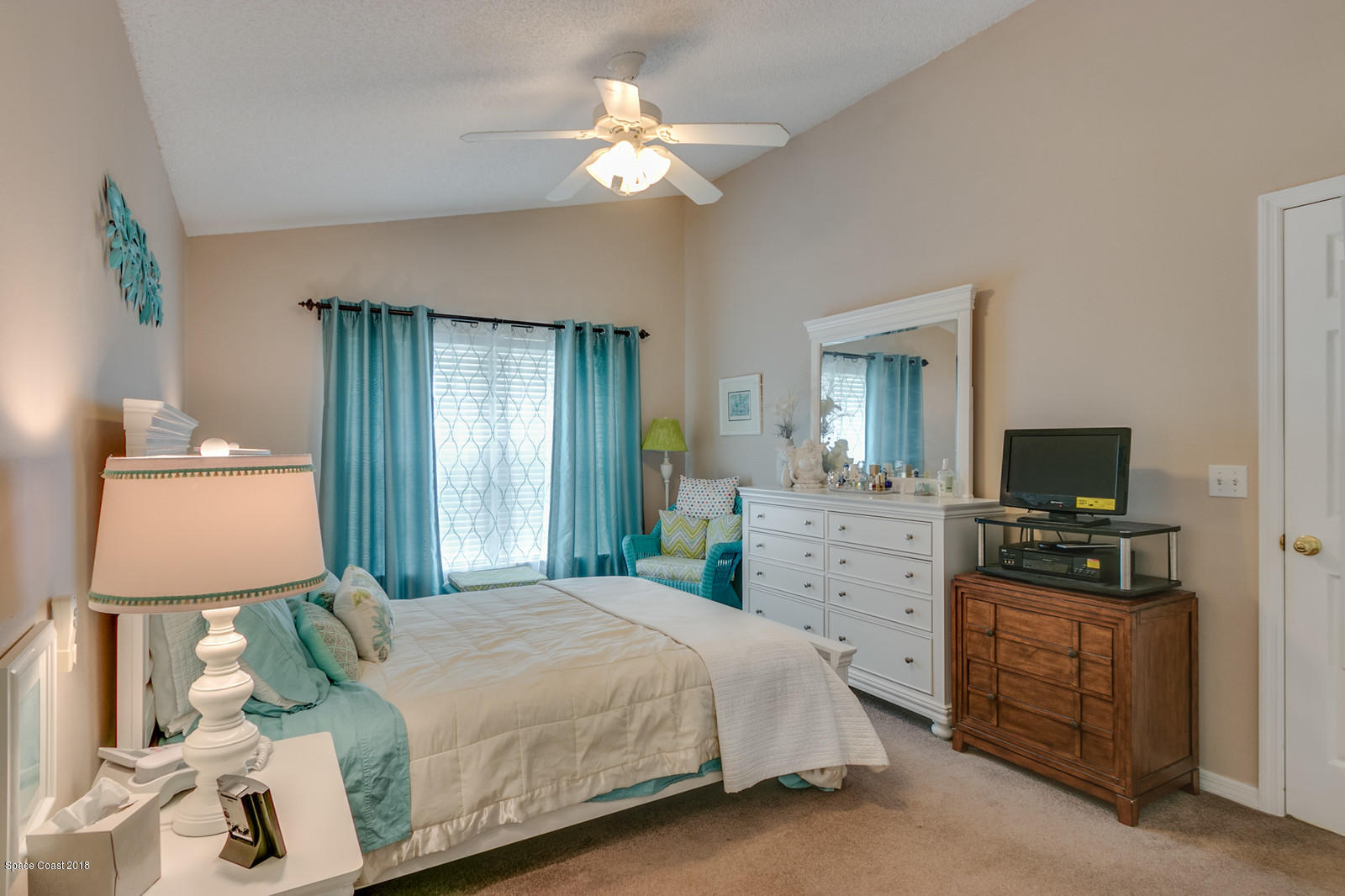 2009 Redwood Circle Palm Bay, FL 32905 - Photo 21 of 32 a bedroom with a bed and a flat tv screen on dresser