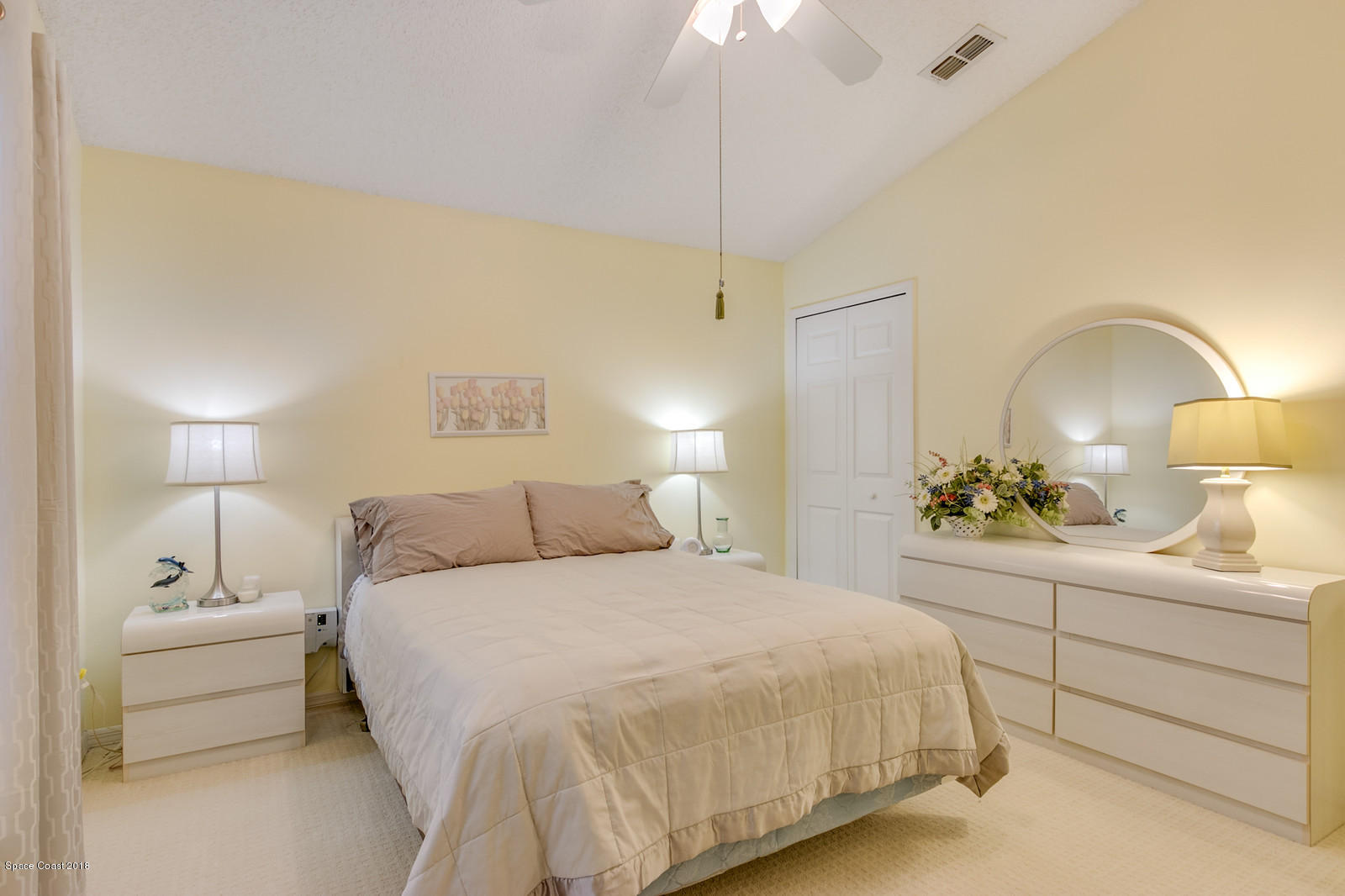 2009 Redwood Circle Palm Bay, FL 32905 - Photo 26 of 32 a bedroom with a bed and a lamp
