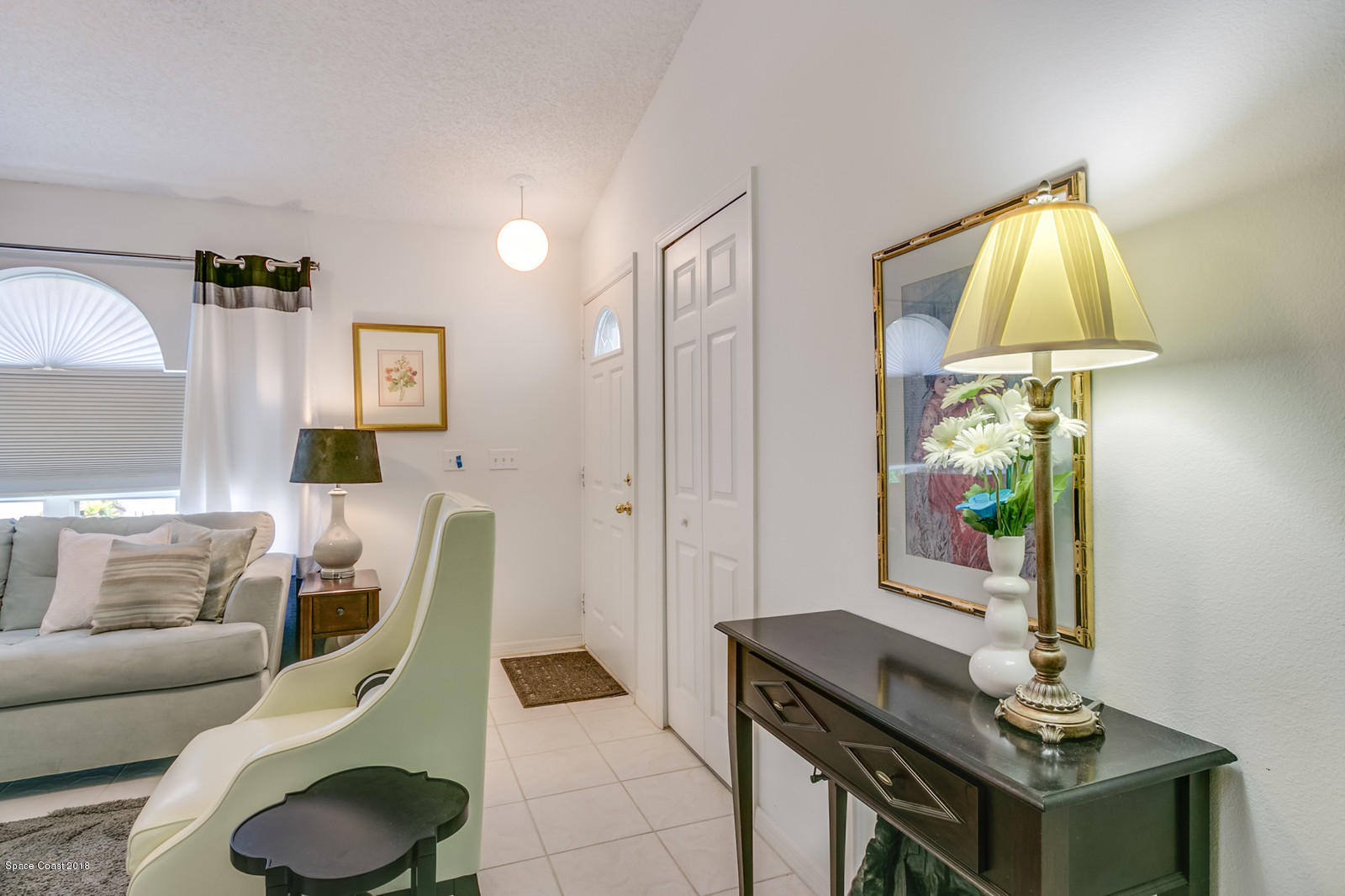 2009 Redwood Circle Palm Bay, FL 32905 - Photo 28 of 32 a living room with furniture and a lamp