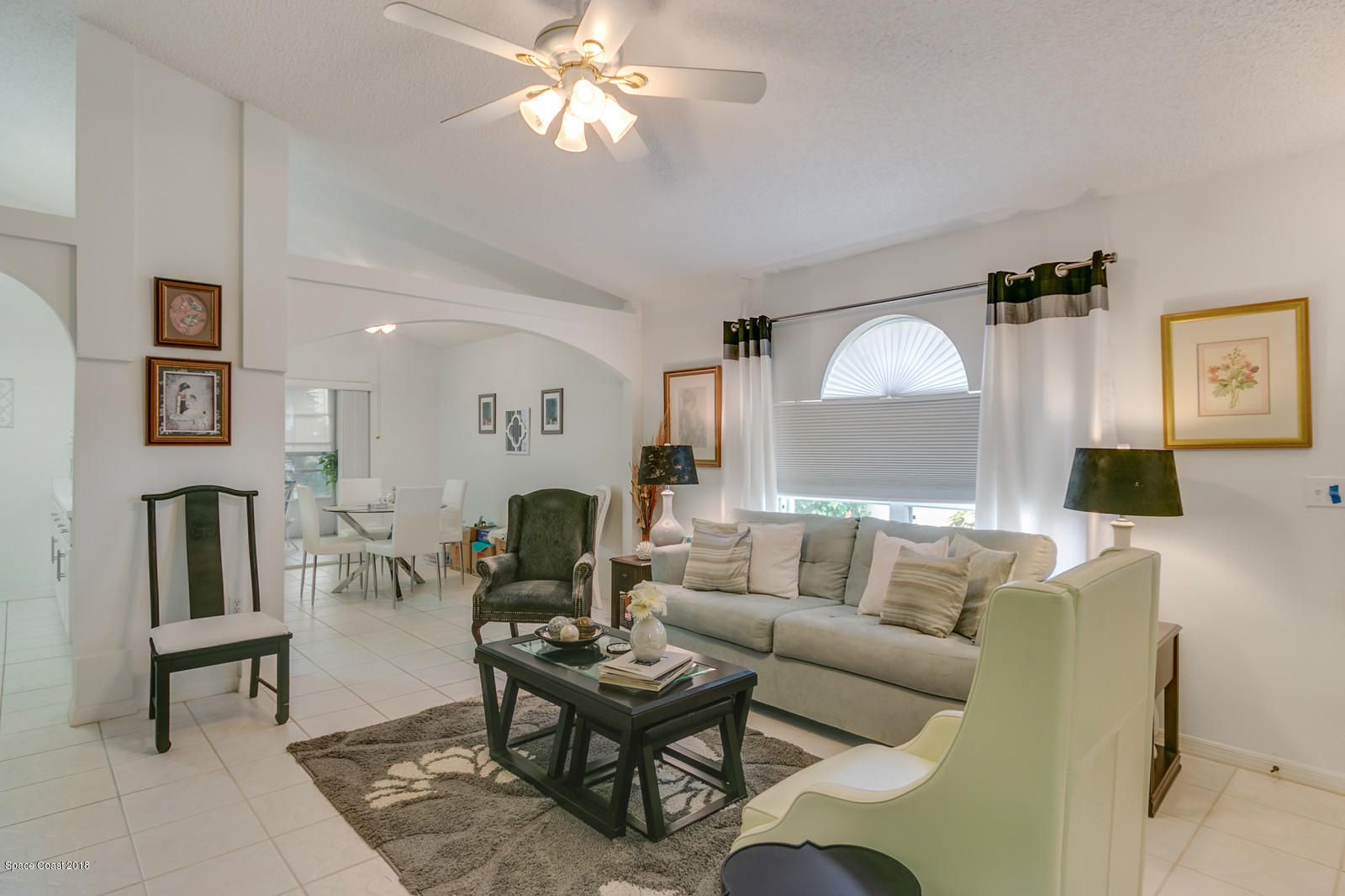 2009 Redwood Circle Palm Bay, FL 32905 - Photo 29 of 32 a living room with furniture a fireplace and a flat screen tv