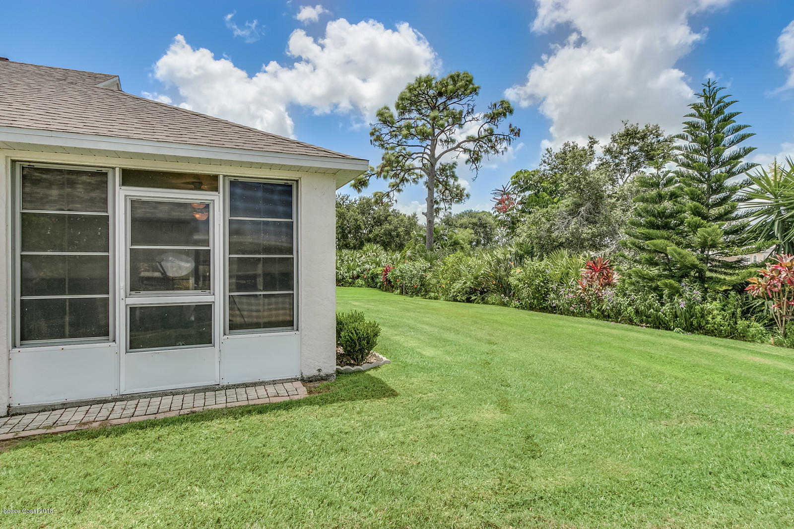 2009 Redwood Circle Palm Bay, FL 32905 - Photo 7 of 32 a view of an house with backyard space and garden