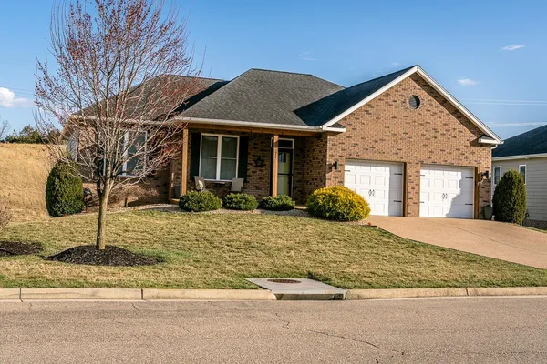a view of a brick building with a bench in patio