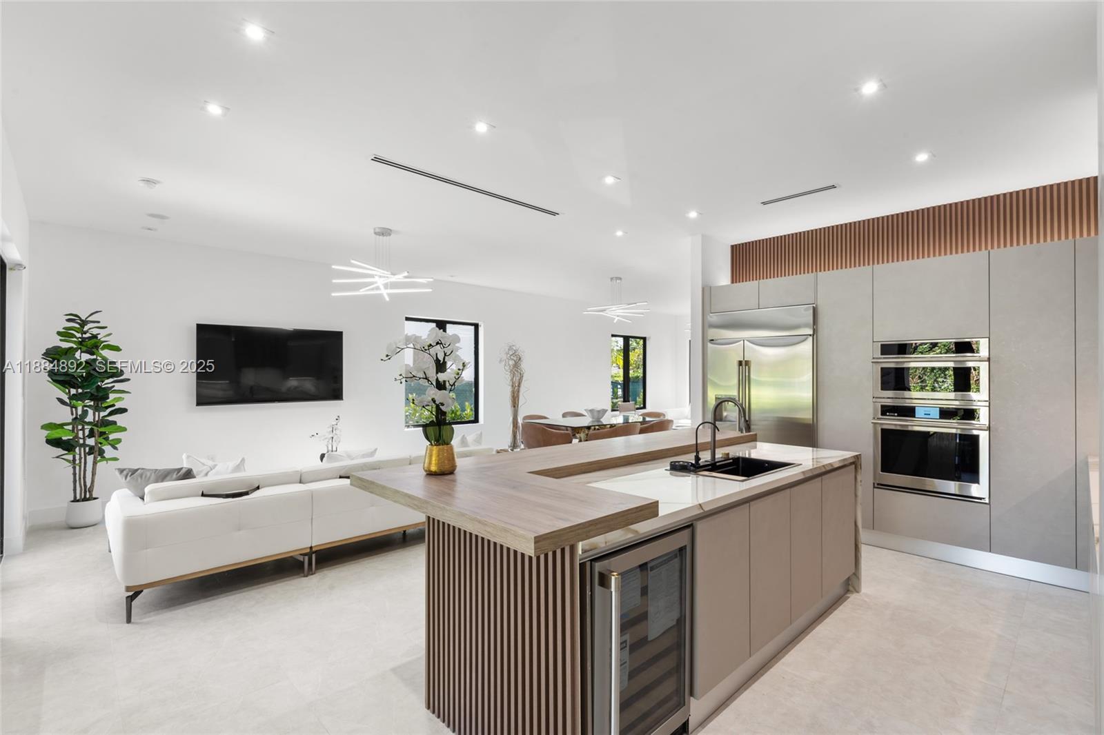 2523 Red Road Miami, FL 33134 - Photo 11 of 39 a living room with stainless steel appliances kitchen island furniture and a flat screen tv