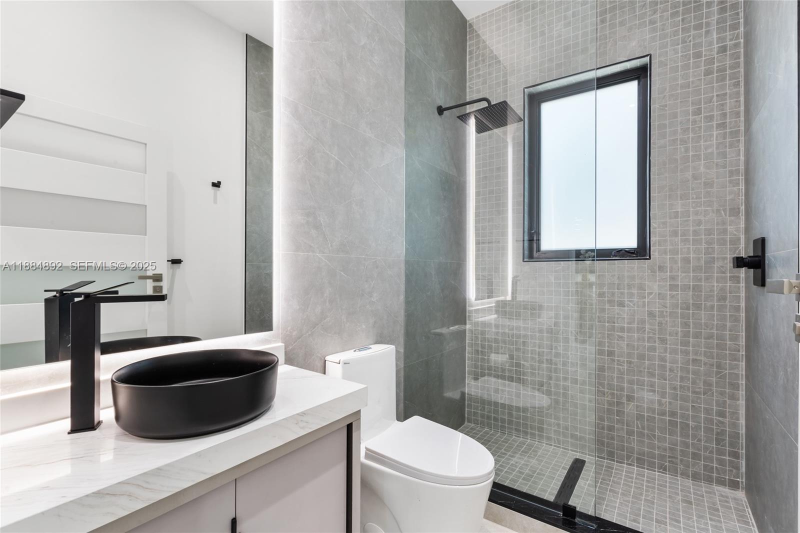 2523 Red Road Miami, FL 33134 - Photo 13 of 39 a bathroom with a toilet a sink and mirror