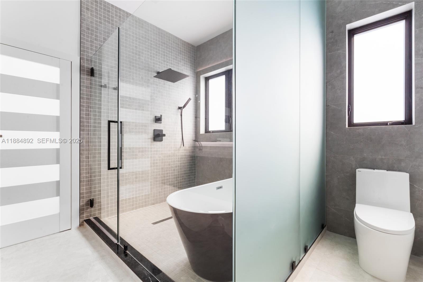 2523 Red Road Miami, FL 33134 - Photo 29 of 39 a bathroom with a toilet and a shower