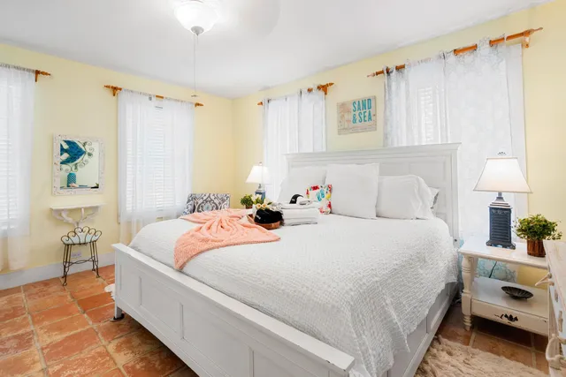 a front view of a house with a yard covered with snow