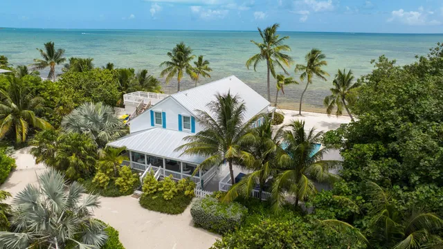 a view of a house with a swimming pool and sitting area