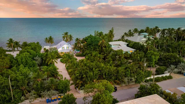 a front view of a house with garden and porch