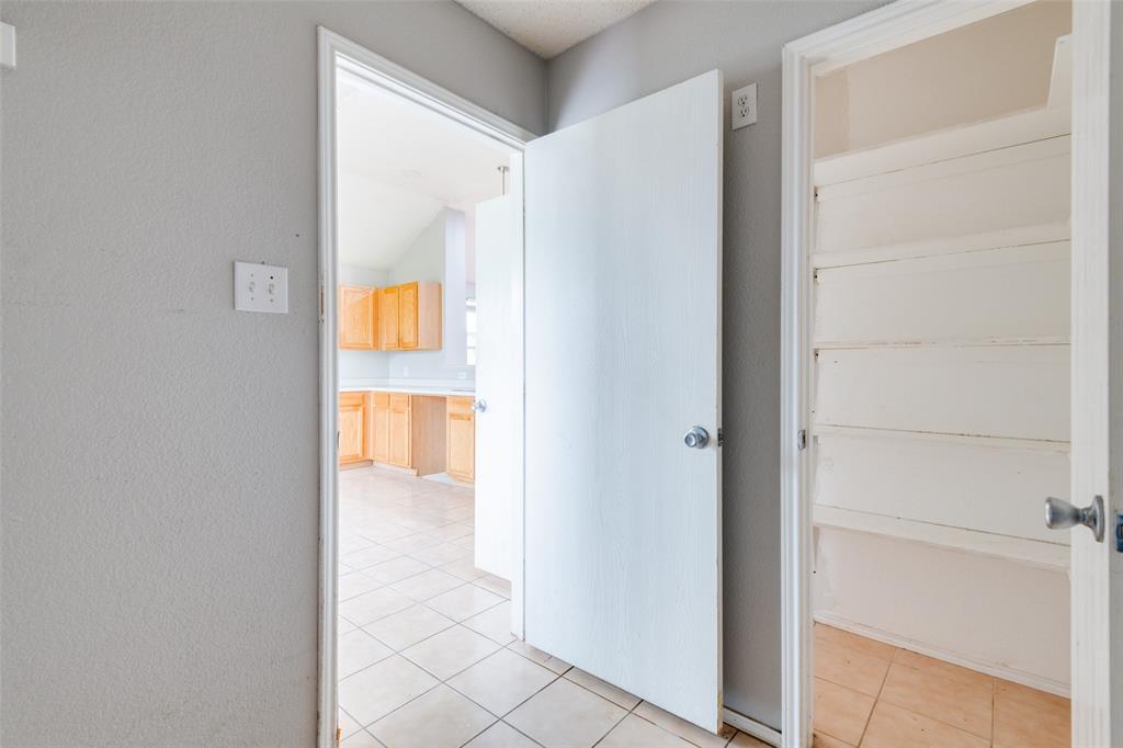 107 Bowie Street Forney, TX 75126 - Photo 11 of 25 a view of a hallway with wooden floor and entryway