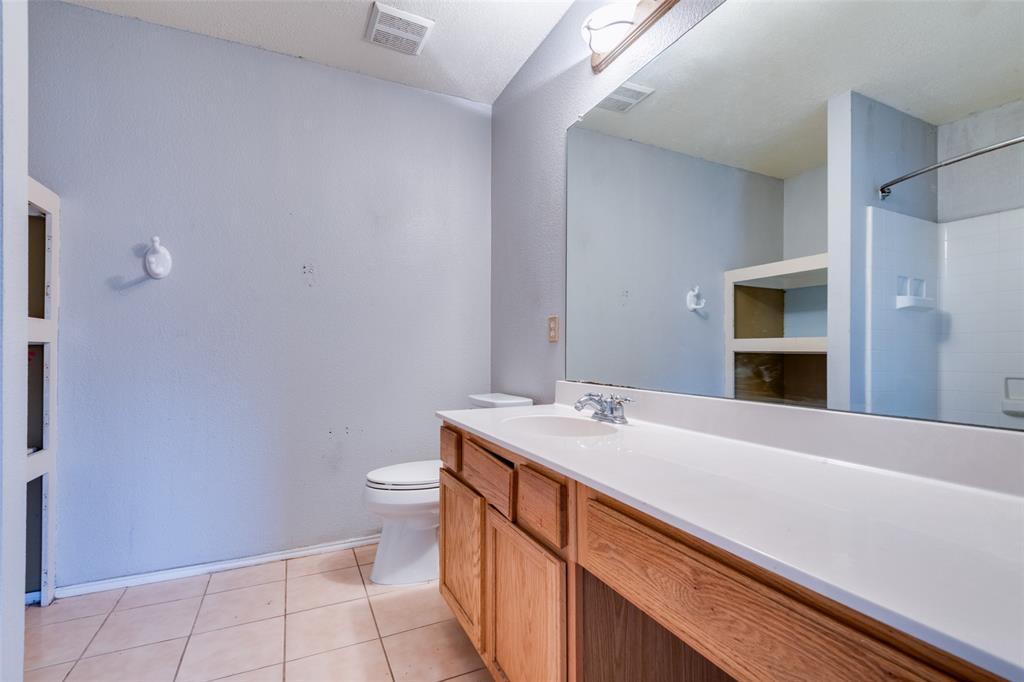 107 Bowie Street Forney, TX 75126 - Photo 17 of 25 a bathroom with a sink a toilet and mirror
