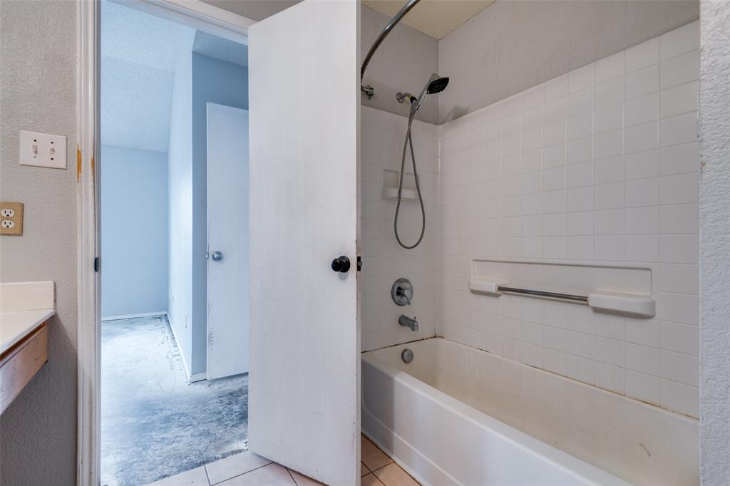 107 Bowie Street Forney, TX 75126 - Photo 18 of 25 a bathroom with a bath tub with a shower
