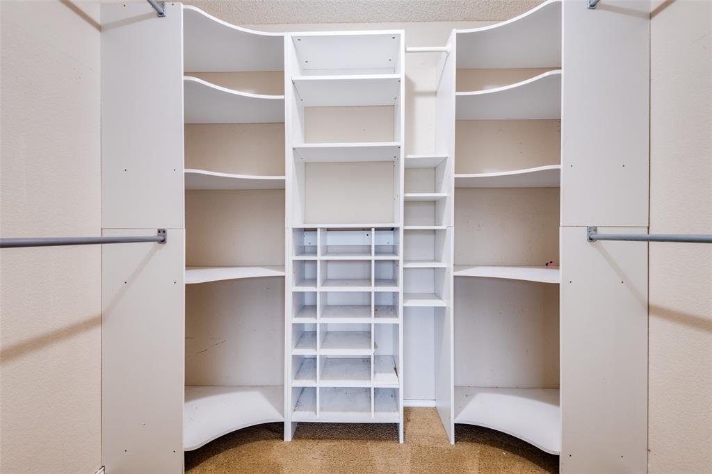107 Bowie Street Forney, TX 75126 - Photo 19 of 25 a view of walk in closet with empty racks
