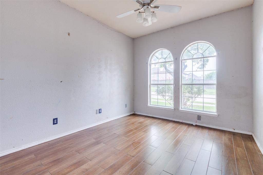 107 Bowie Street Forney, TX 75126 - Photo 21 of 25 a view of an empty room with wooden floor and window