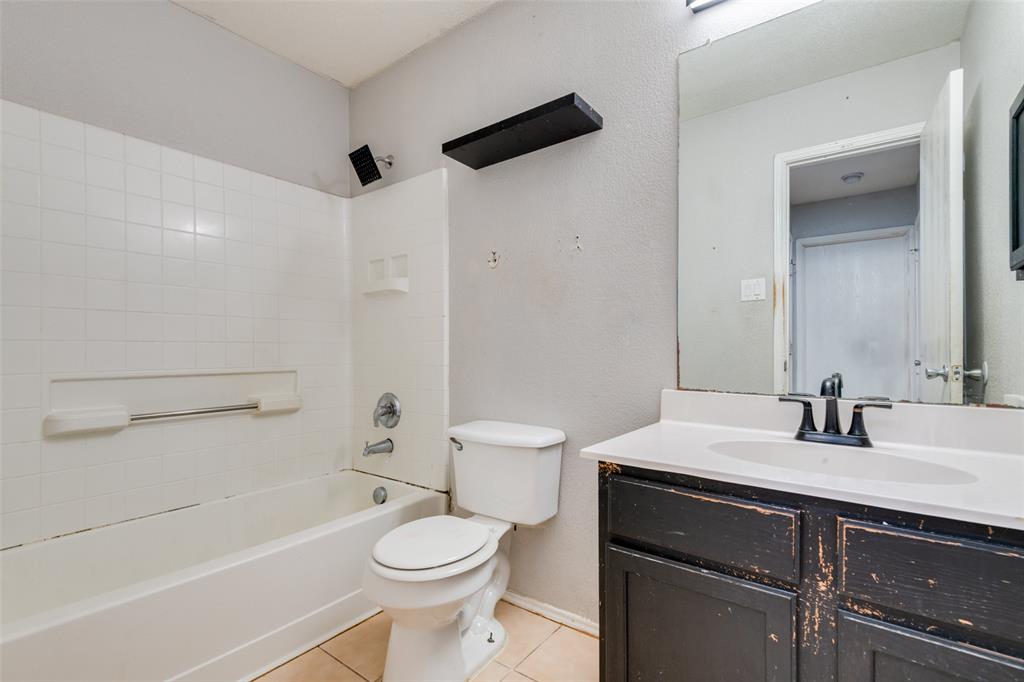 107 Bowie Street Forney, TX 75126 - Photo 22 of 25 a bathroom with a sink a toilet and shower