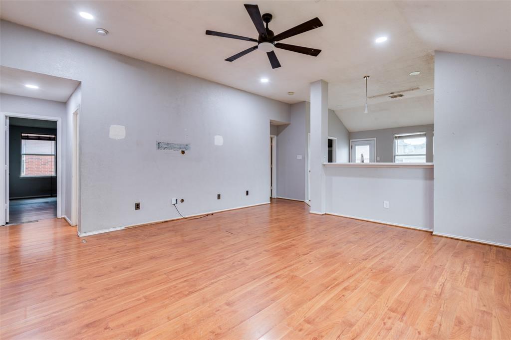 107 Bowie Street Forney, TX 75126 - Photo 6 of 25 an empty room with wooden floor and windows