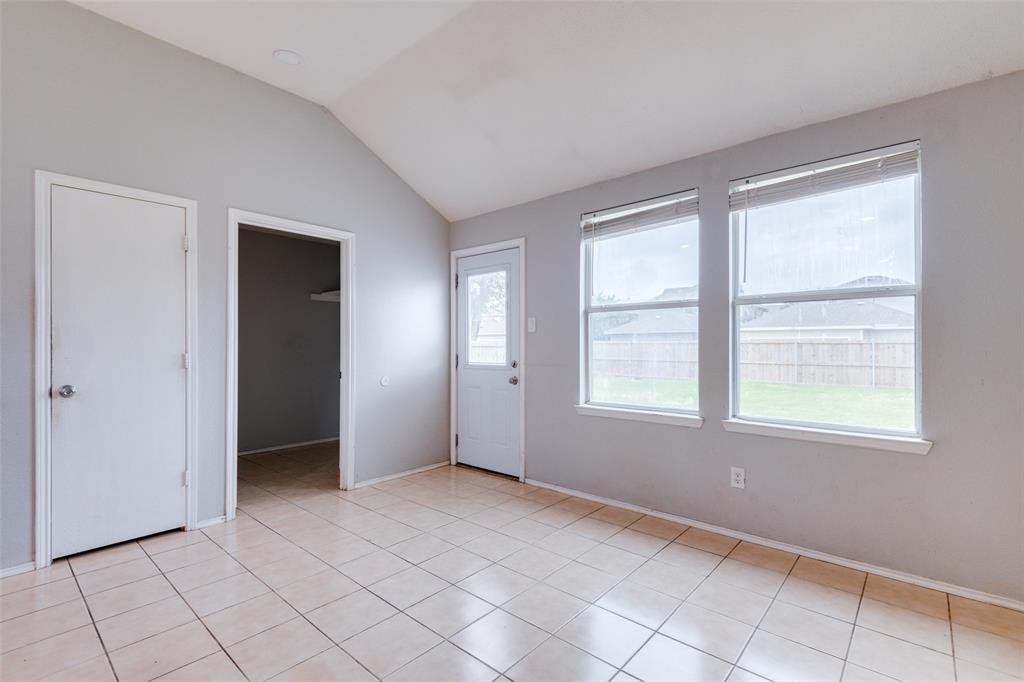 107 Bowie Street Forney, TX 75126 - Photo 10 of 25 a view of an empty room with window and chandelier fan