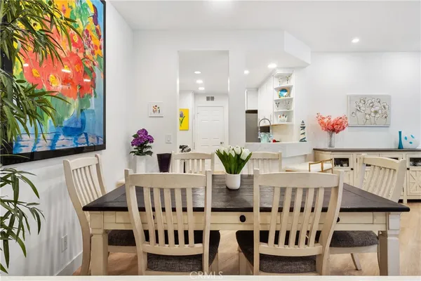 a view of a dining room with furniture and a potted plant