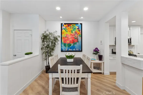 a living room with furniture a chandelier and a rug