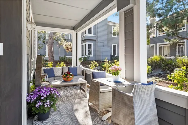 a outdoor space with tables and chairs potted plants