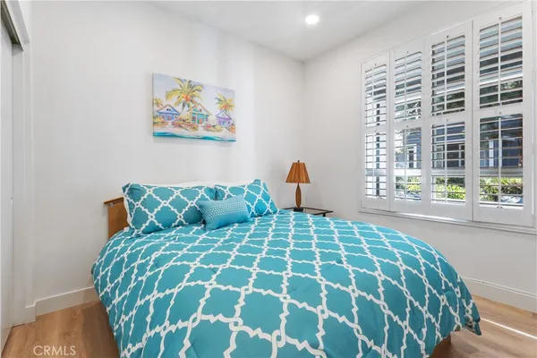 a large bed sitting in a bedroom next to a window