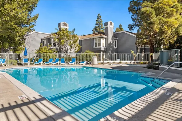 a view of a swimming pool with outdoor seating