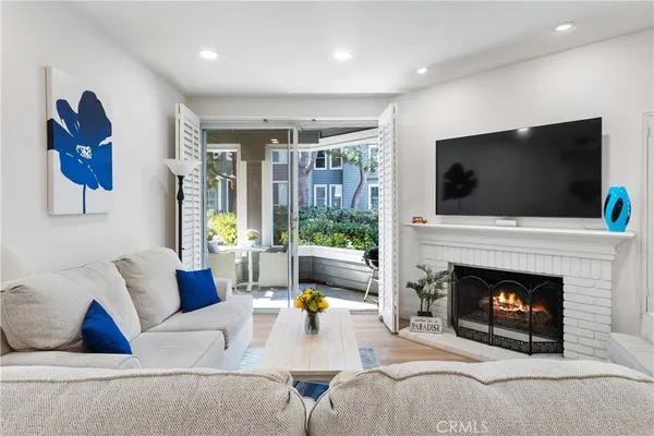 a living room with furniture a fireplace and a flat screen tv
