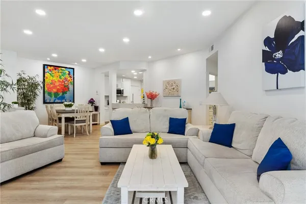 a living room with furniture and kitchen view