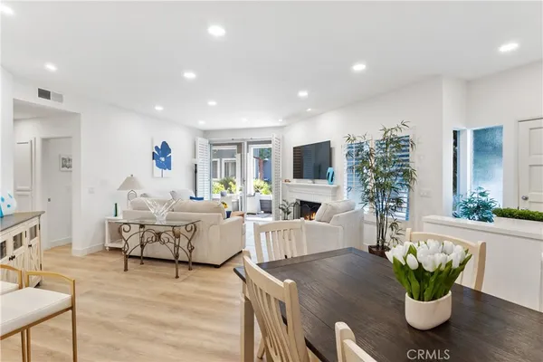 a living room with furniture potted plant and a flat screen tv