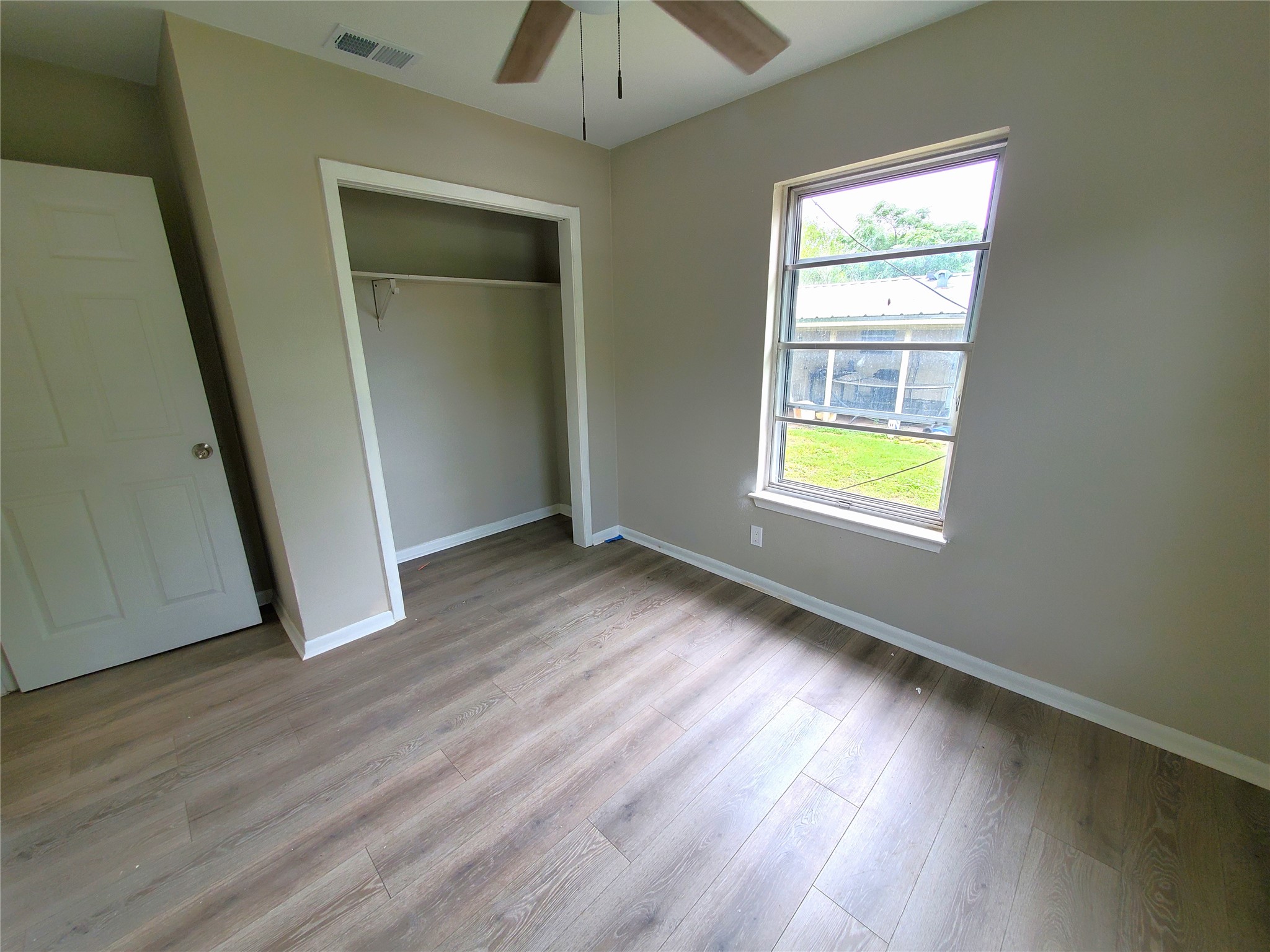 8907 Shepard Drive Austin, TX 78753 - Photo 8 of 14 an empty room with wooden floor and windows