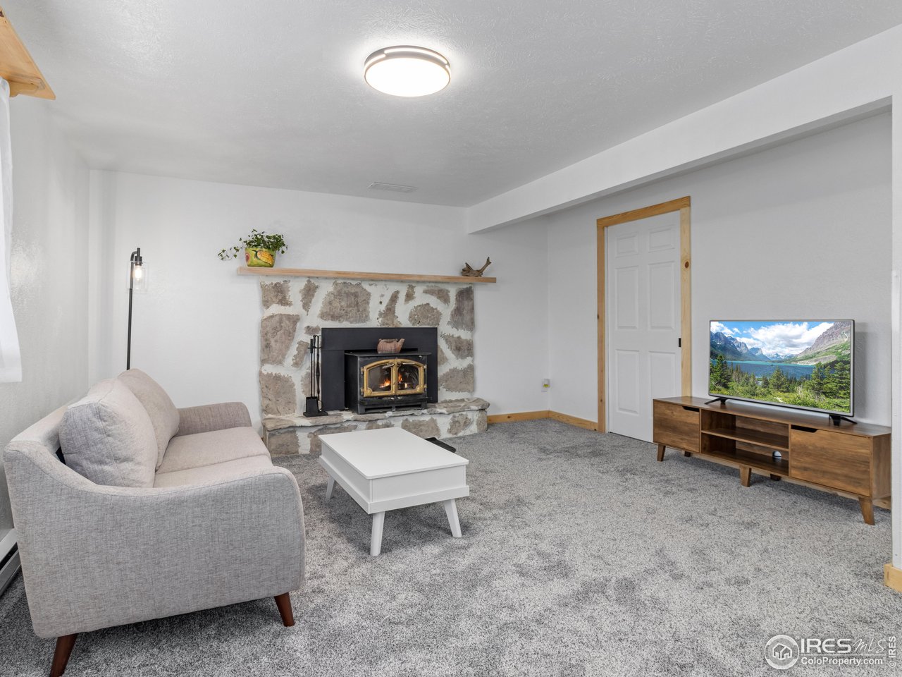 1873 Ranch Circle Estes Park, CO 80517 - Photo 7 of 33 Sizable Lower Level Rec Room With A Fireplace Insert to Keep You Cozy